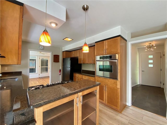 919 Fassett Rd, Elmira, NY 14905 - kitchen featuring oven, freestanding refrigerator, brown cabinetry, a peninsula, and pendant lighting