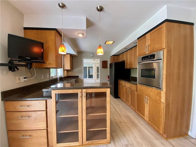 919 Fassett Rd, Elmira, NY 14905 - kitchen featuring stainless steel oven, freestanding refrigerator, light wood finished floors, pendant lighting, and a peninsula