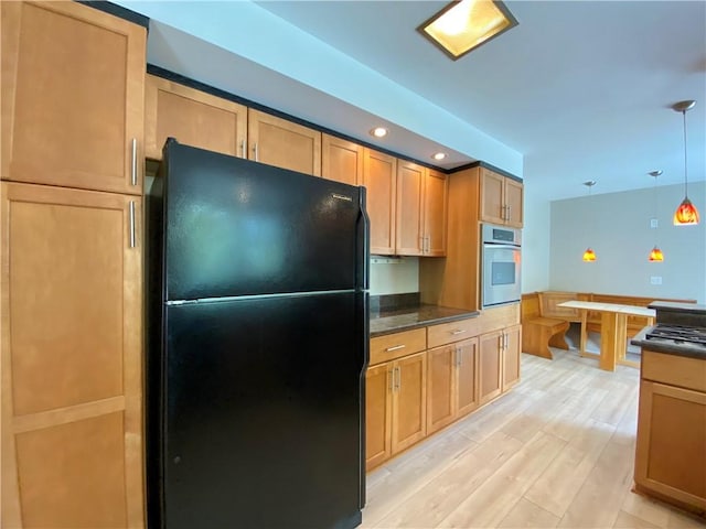 919 Fassett Rd, Elmira, NY 14905 - kitchen with freestanding refrigerator, oven, dark countertops, light wood-style floors, and recessed lighting