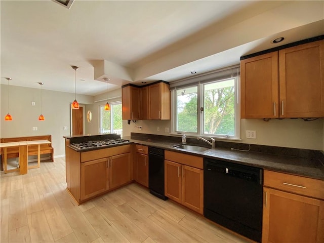 919 Fassett Rd, Elmira, NY 14905 - kitchen featuring dishwasher, dark countertops, a peninsula, stainless steel gas stovetop, and brown cabinets
