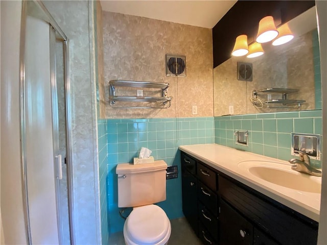 919 Fassett Rd, Elmira, NY 14905 - bathroom featuring tile walls, a stall shower, vanity, and wainscoting