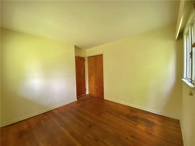 919 Fassett Rd, Elmira, NY 14905 - empty room with dark wood-type flooring and baseboards