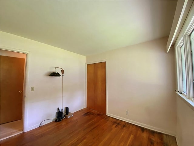 919 Fassett Rd, Elmira, NY 14905 - unfurnished bedroom featuring wood finished floors and a closet