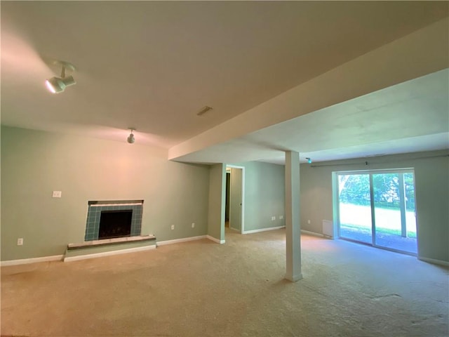 919 Fassett Rd, Elmira, NY 14905 - unfurnished living room featuring carpet flooring and a tiled fireplace
