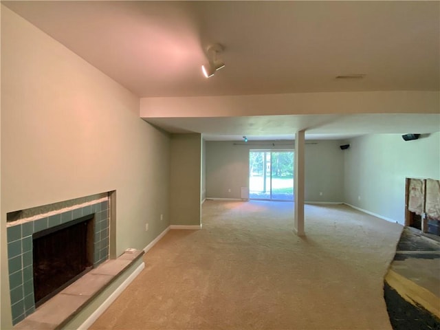 919 Fassett Rd, Elmira, NY 14905 - unfurnished living room featuring a tile fireplace and carpet