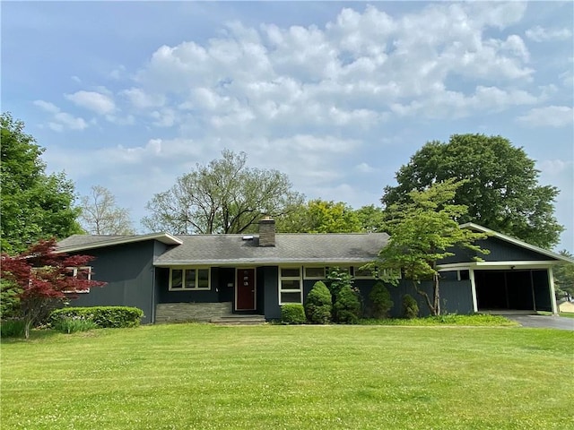 919 Fassett Rd, Elmira, NY 14905 - view of front of house featuring a chimney, a front lawn, driveway, and an attached garage