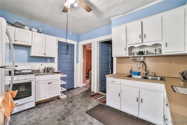 132 Ryan St, Buffalo, NY 14210 - kitchen with white gas range oven, ceiling fan, and white cabinetry