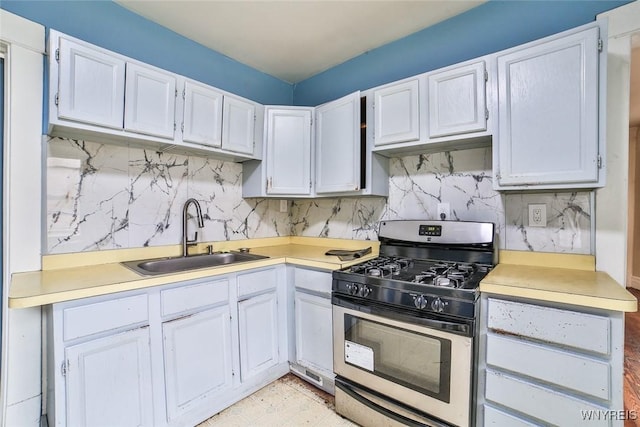 132 Ryan St, Buffalo, NY 14210 - kitchen featuring stainless steel gas stove, light countertops, tasteful backsplash, and white cabinetry