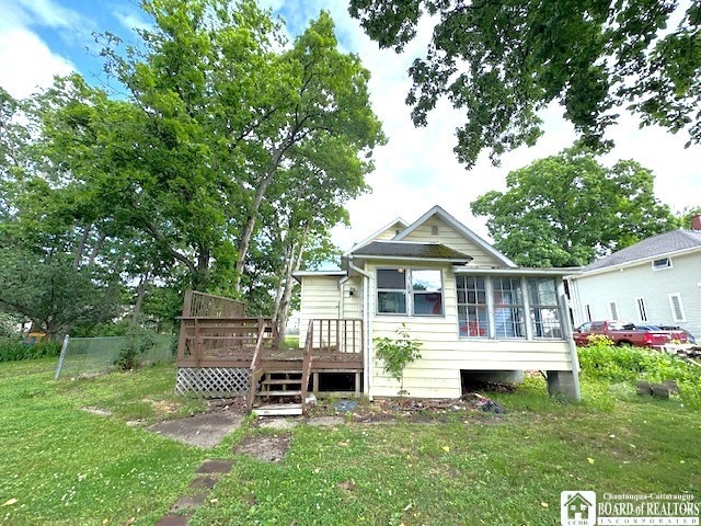 3 Jaekle Ave, Hanover, NY 14136 - rear view of property featuring a deck, a yard, and a sunroom