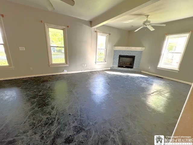 3 Jaekle Ave, Hanover, NY 14136 - unfurnished living room with ceiling fan, healthy amount of natural light, a tiled fireplace, concrete floors, and beamed ceiling