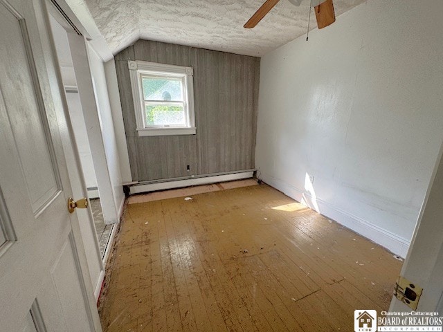 3 Jaekle Ave, Hanover, NY 14136 - unfurnished room featuring baseboard heating, a ceiling fan, lofted ceiling, hardwood / wood-style flooring, and a textured ceiling
