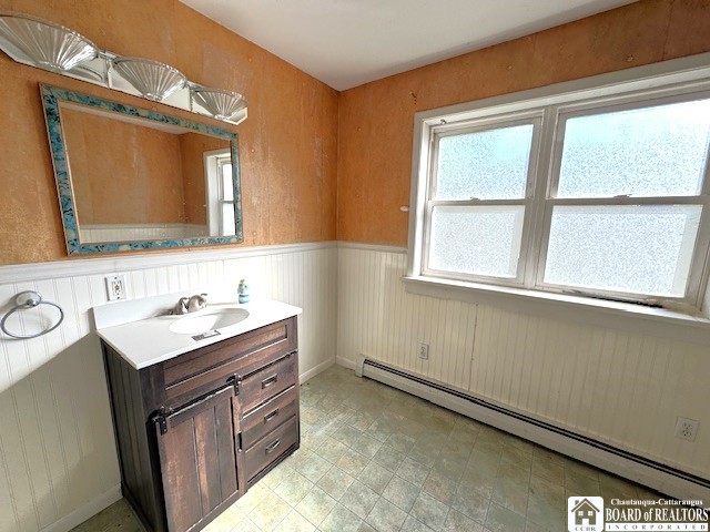 3 Jaekle Ave, Hanover, NY 14136 - bathroom featuring a baseboard radiator, vanity, and wainscoting