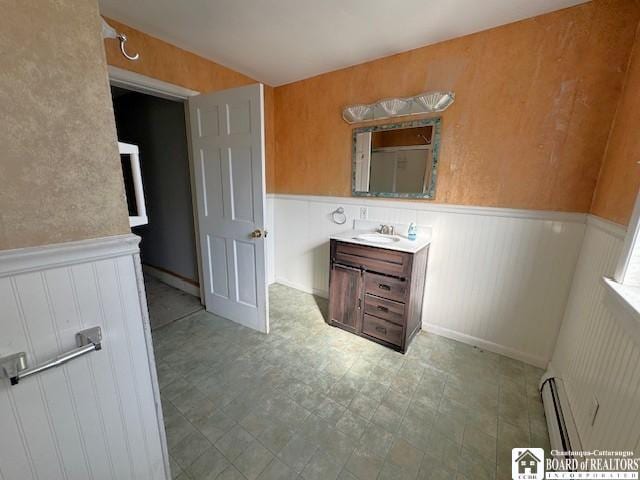 3 Jaekle Ave, Hanover, NY 14136 - bathroom with baseboard heating, wainscoting, and vanity
