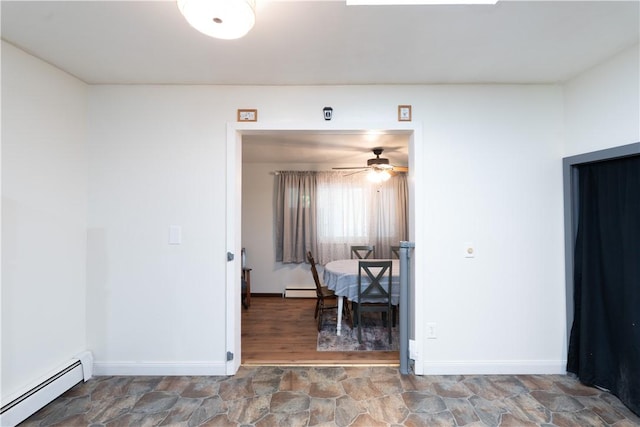 207 County Road 7, Manchester, NY 14432 - dining room featuring a baseboard radiator, a ceiling fan, and stone finish flooring