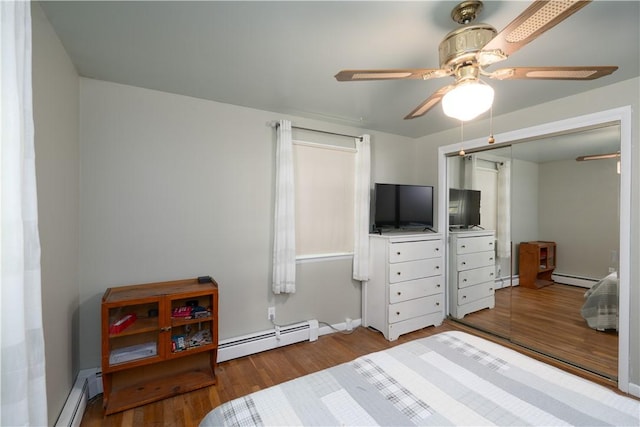 207 County Road 7, Manchester, NY 14432 - bedroom featuring a baseboard heating unit, wood finished floors, ceiling fan, and a closet