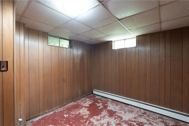 207 County Road 7, Manchester, NY 14432 - below grade area with baseboard heating, a paneled ceiling, healthy amount of natural light, and wooden walls