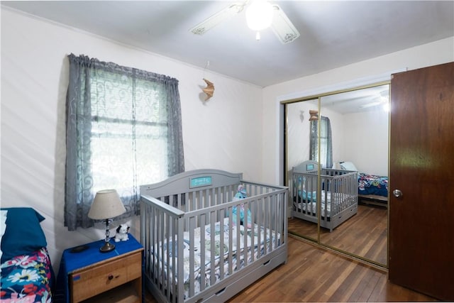 207 County Road 7, Manchester, NY 14432 - bedroom featuring wood finished floors, a closet, a ceiling fan, and a nursery area