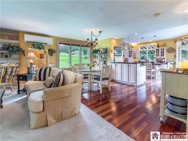 4627 Anderson Dr, Ellery, NY 14712 - living room featuring a wall unit AC, wood-type flooring, plenty of natural light, a chandelier, and recessed lighting