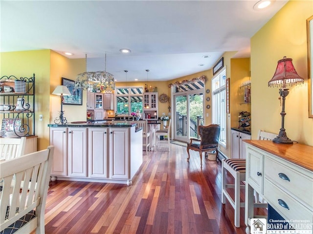 4627 Anderson Dr, Ellery, NY 14712 - kitchen with wood finished floors, dark countertops, a peninsula, glass insert cabinets, and recessed lighting