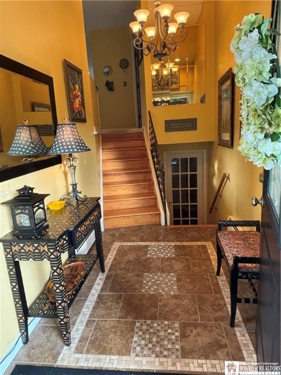 4627 Anderson Dr, Ellery, NY 14712 - stairway featuring a chandelier and stone finish flooring