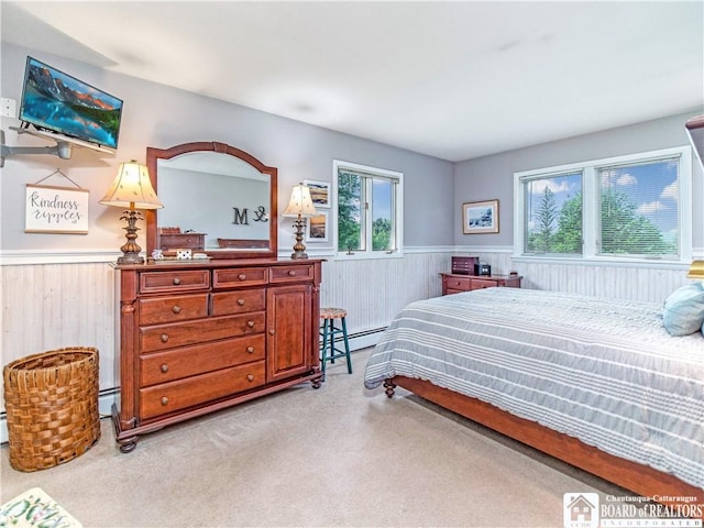 4627 Anderson Dr, Ellery, NY 14712 - bedroom featuring wainscoting, baseboard heating, light carpet, a baseboard heating unit, and wooden walls