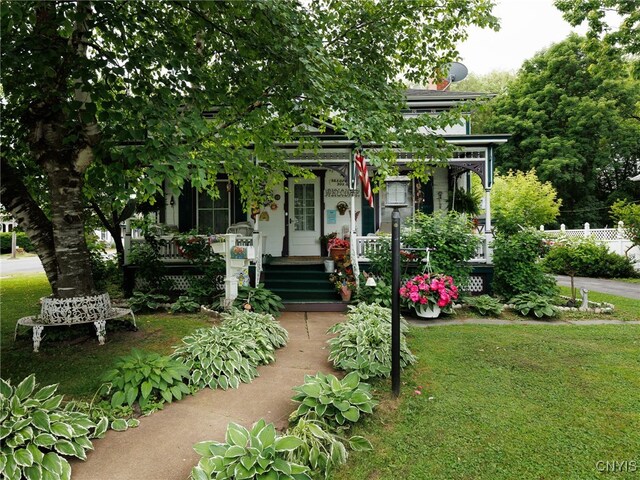 303 Mullin St, Watertown-City, NY 13601 - view of front facade with a porch and a front yard