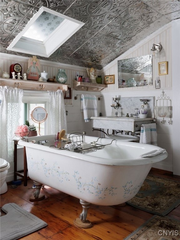 303 Mullin St, Watertown-City, NY 13601 - full bath featuring an ornate ceiling, hardwood / wood-style floors, ornamental molding, and a freestanding tub