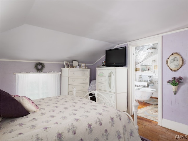 303 Mullin St, Watertown-City, NY 13601 - bedroom with lofted ceiling, wood finished floors, and ensuite bath