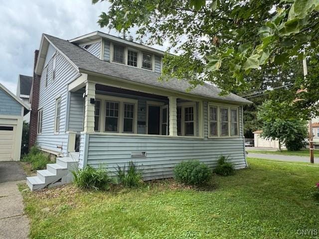 15 Broadway Ave, Cortland, NY 13045 - view of front of home featuring a front yard, a garage, an outbuilding, and driveway