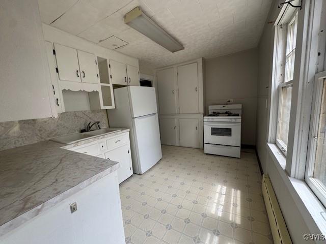 15 Broadway Ave, Cortland, NY 13045 - kitchen featuring white appliances, light floors, plenty of natural light, and light countertops