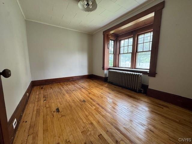 15 Broadway Ave, Cortland, NY 13045 - unfurnished room featuring radiator, wood-type flooring, and ornamental molding