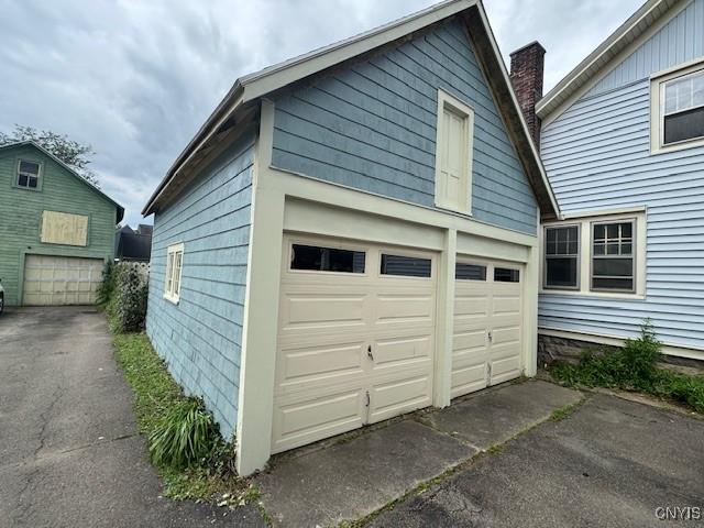 15 Broadway Ave, Cortland, NY 13045 - garage featuring asphalt driveway