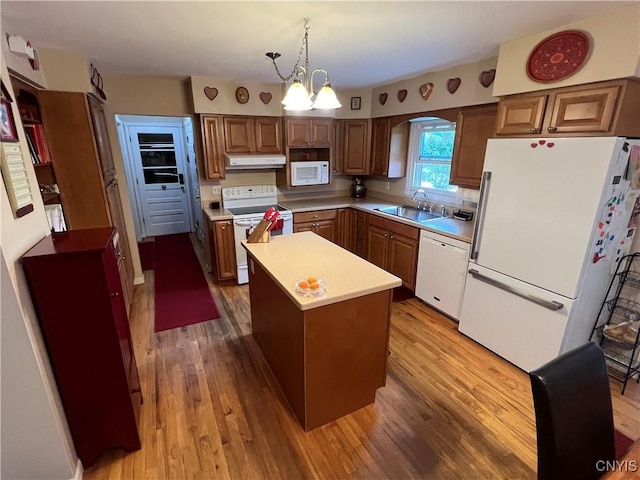 412 County Route 62, Sandy Creek, NY 13142 - kitchen with white appliances, under cabinet range hood, wood finished floors, arched walkways, and light countertops