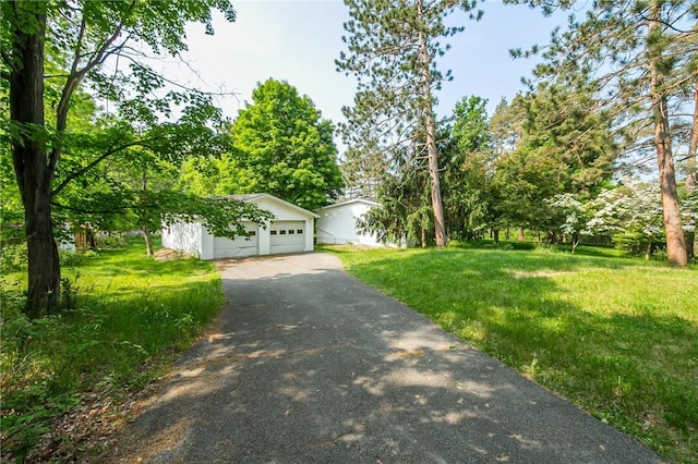 223 N Vine Valley Rd, Middlesex, NY 14544 - view of front facade with driveway and a front yard