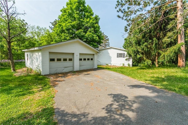 223 N Vine Valley Rd, Middlesex, NY 14544 - view of front of home with a garage, an outbuilding, and a front yard