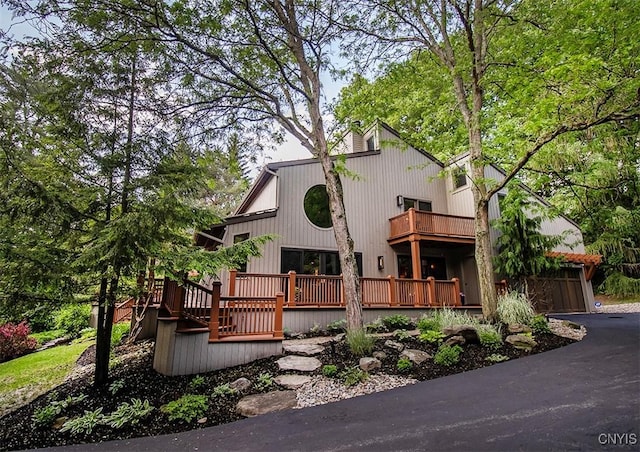 4458 E Lake Rd, Cazenovia, NY 13035 - view of front of house featuring a balcony, a wooden deck, and a garage