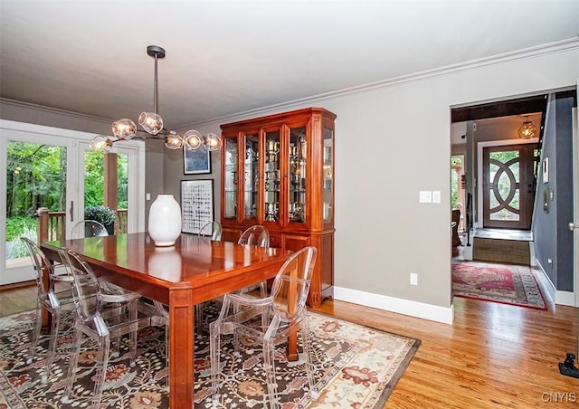 4458 E Lake Rd, Cazenovia, NY 13035 - dining area with crown molding, light wood finished floors, and a chandelier