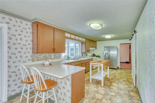 1541 Shoecraft Rd, Penfield, NY 14526 - kitchen featuring stainless steel fridge with ice dispenser, a peninsula, light countertops, a kitchen breakfast bar, and range