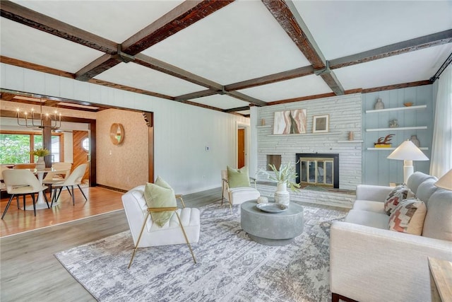 1541 Shoecraft Rd, Penfield, NY 14526 - living area featuring coffered ceiling, wood finished floors, a chandelier, beam ceiling, and a brick fireplace