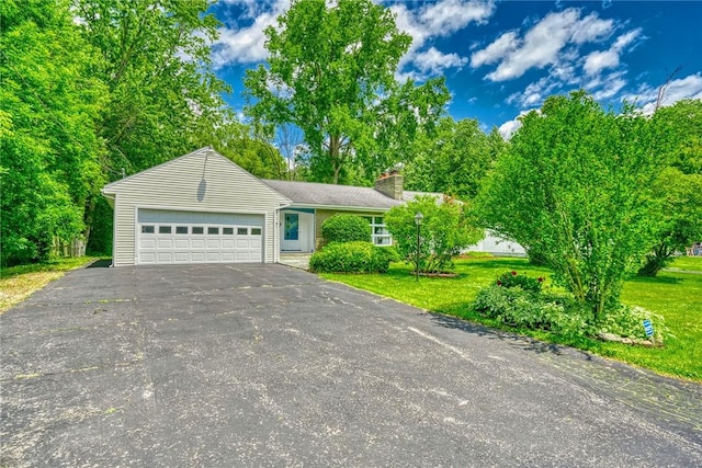 1541 Shoecraft Rd, Penfield, NY 14526 - view of front of house featuring driveway, an attached garage, a chimney, and a front lawn