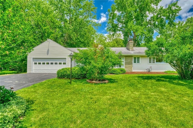1541 Shoecraft Rd, Penfield, NY 14526 - view of front facade with a front lawn, a chimney, asphalt driveway, and a garage