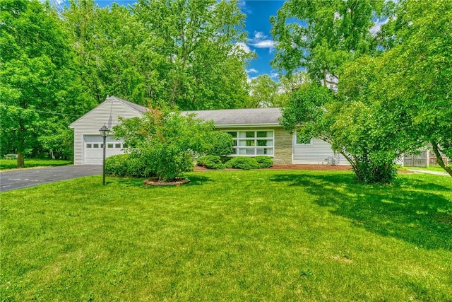 1541 Shoecraft Rd, Penfield, NY 14526 - view of front of house featuring asphalt driveway, an attached garage, and a front lawn