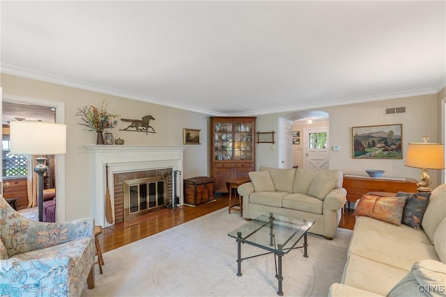 2 Morton Rd, Dewitt, NY 13214 - living room with wood finished floors, ornamental molding, arched walkways, and a fireplace