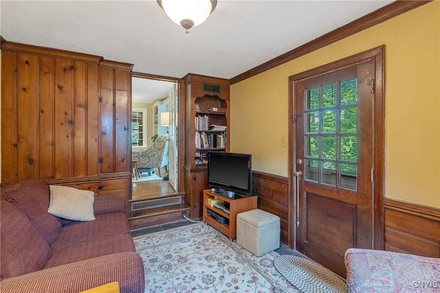 2 Morton Rd, Dewitt, NY 13214 - living room featuring crown molding, a wainscoted wall, and wooden walls