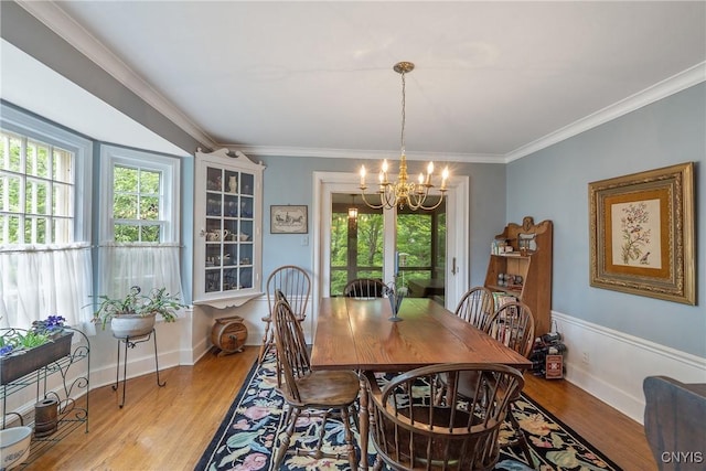 2 Morton Rd, Dewitt, NY 13214 - dining room featuring a chandelier, wood finished floors, and crown molding