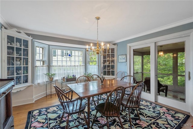 2 Morton Rd, Dewitt, NY 13214 - dining room with a chandelier, ornamental molding, and wood finished floors