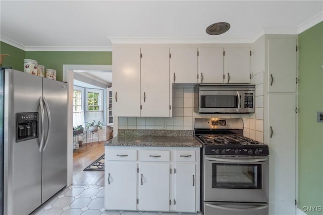 2 Morton Rd, Dewitt, NY 13214 - kitchen featuring stainless steel appliances, backsplash, ornamental molding, and white cabinets
