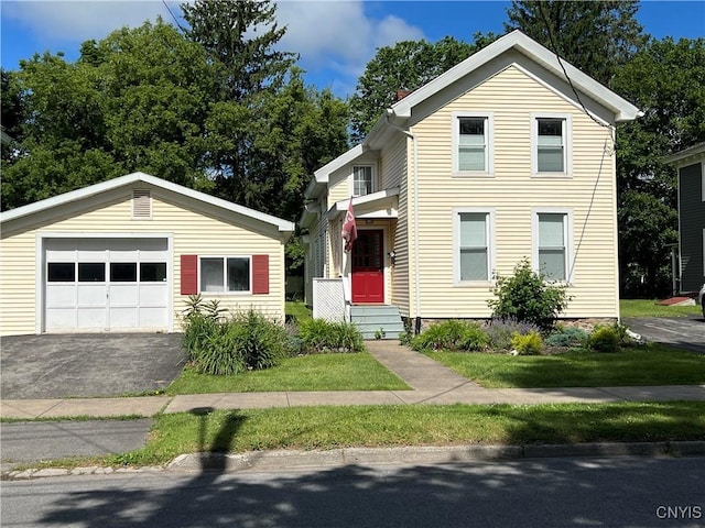 10 Montgomery St, Hamilton, NY 13346 - view of front of house with an outdoor structure, a garage, and asphalt driveway