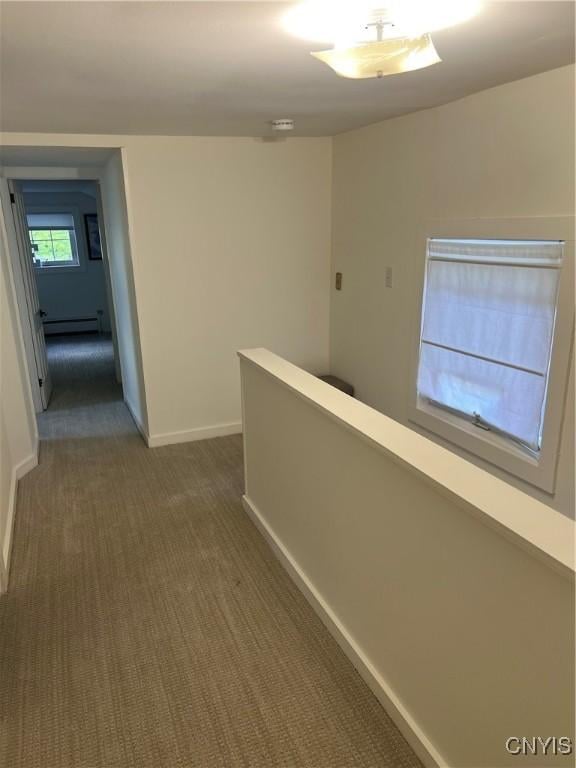 10 Montgomery St, Hamilton, NY 13346 - hallway featuring dark colored carpet, a baseboard radiator, and an upstairs landing