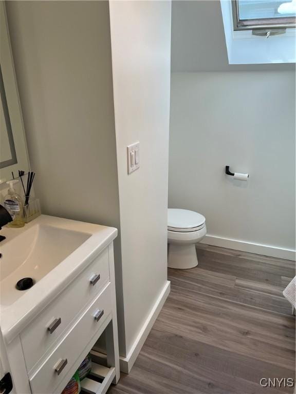 10 Montgomery St, Hamilton, NY 13346 - half bath with vanity, a skylight, and wood finished floors